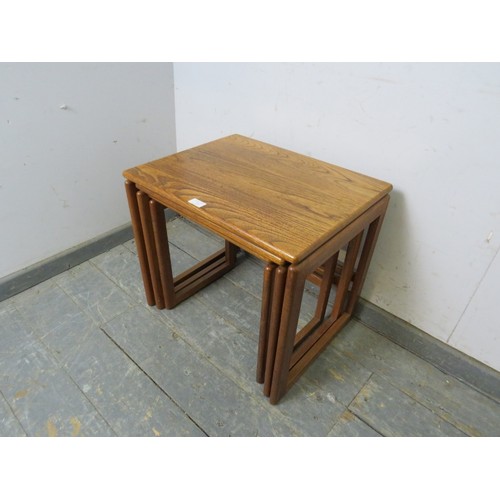 733 - A set of three mid-century ash nesting tables, on rail supports. 
H48cm W54cm D43cm approx.
Conditio... 