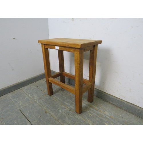 734 - A vintage light oak stool in the manner of Robert Thompson/Mouseman, on square supports with stretch... 