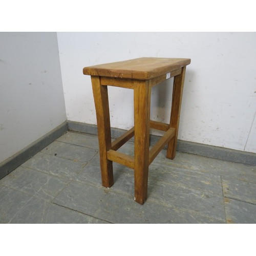 734 - A vintage light oak stool in the manner of Robert Thompson/Mouseman, on square supports with stretch... 