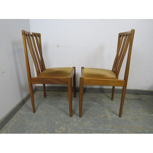 738 - A set of four mid-century teak dining chairs by Meredew, the seats covered in brown velour, on turne... 