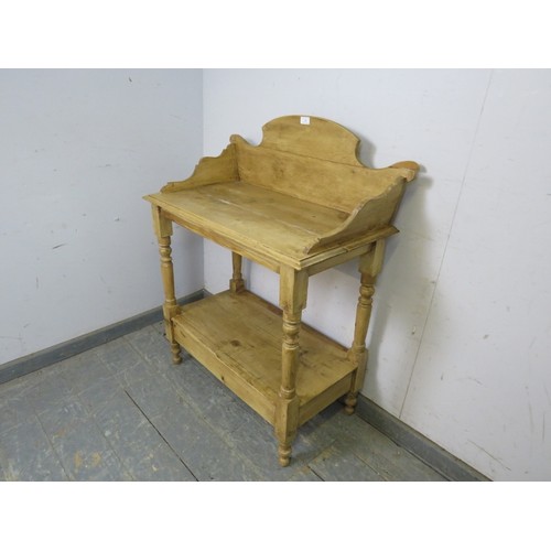 742 - A Continental antique pine washstand, having a shaped ¾ gallery, on turned and block supports united... 