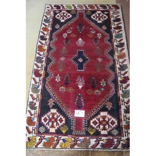 852 - South west Persian Qashqai rug, central motif on red ground. Quater spandrels and wide borders.  205... 