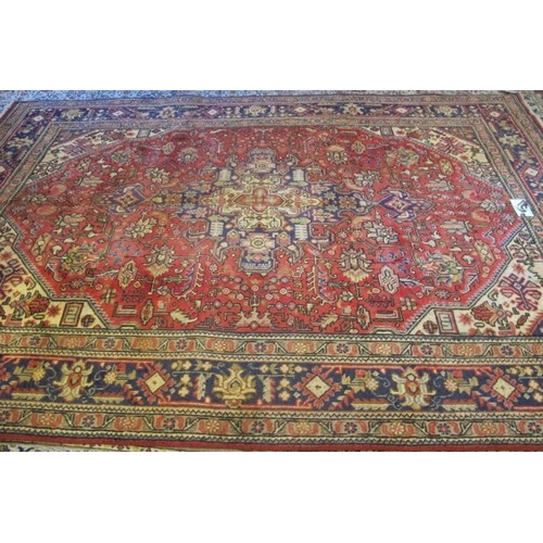 855 - North West Persian Tabriz carpet.  Highly patterned central field on red ground and wide borders.  2... 