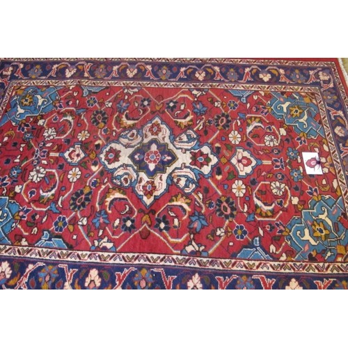 856 - North West Persian Mahal rug, central motif on cream ground surrounded by a floral design and wide b... 