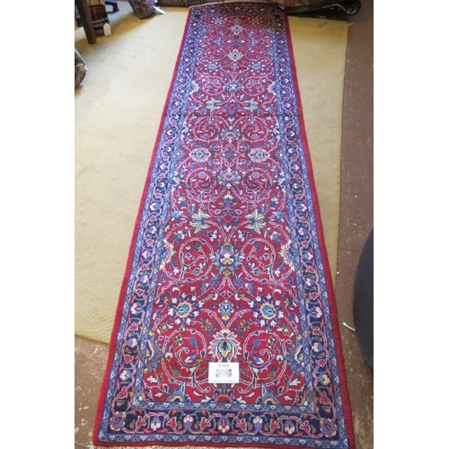 857 - North West Persian Sarouk runner, central floral field on red ground and a patterned border.  300cm ... 