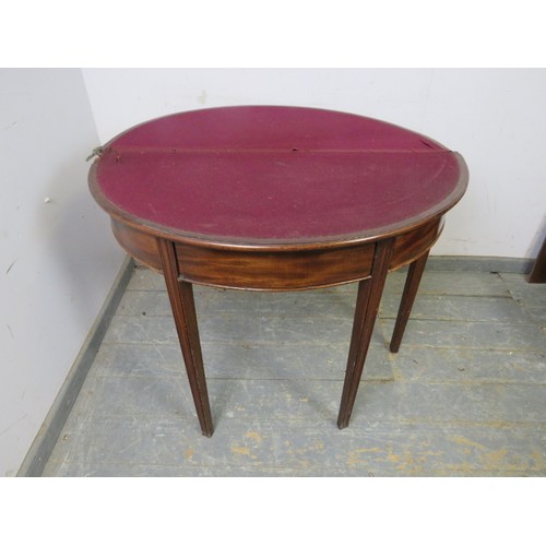 730A - A George III mahogany demi-lune folding card table, crossbanded and with inlaid satinwood panel, hou... 