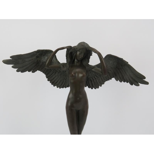 131 - A 20th century bronze figure of a winged nymph mounted on a black marble base.  Unsigned .  Height 5... 