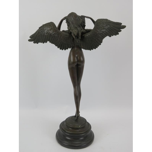 131 - A 20th century bronze figure of a winged nymph mounted on a black marble base.  Unsigned .  Height 5... 