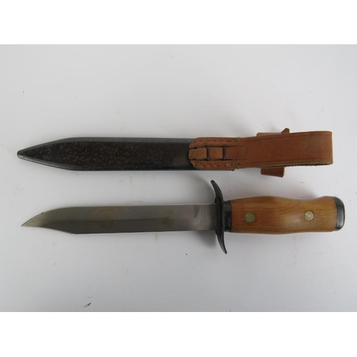 165 - A Polish WZ55 paratrooper combat knife with scabbard, dated 1955. Marked ’11 1955’ to the ricasso. 2... 