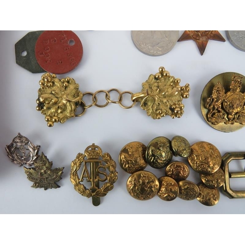 173 - A group of British WWII medals together with badges, buttons, accessories, a cape chain and two Unio... 