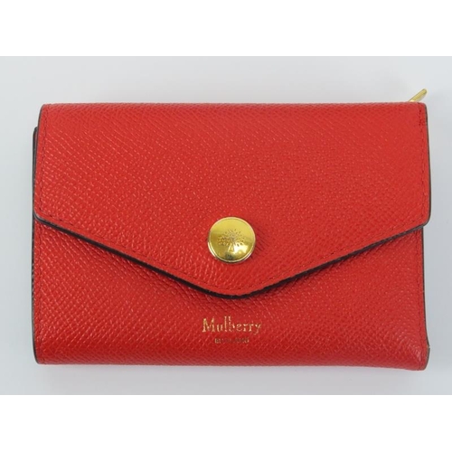 224 - A Mulberry poppy red leather folded multi-card wallet. Gold hardware, cash, card and coin storage. O... 