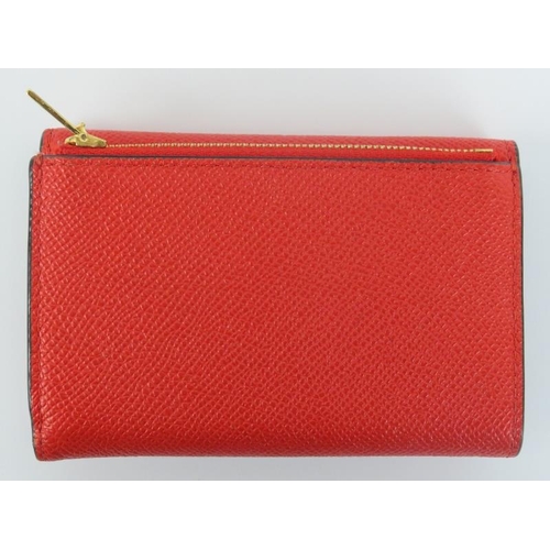 224 - A Mulberry poppy red leather folded multi-card wallet. Gold hardware, cash, card and coin storage. O... 