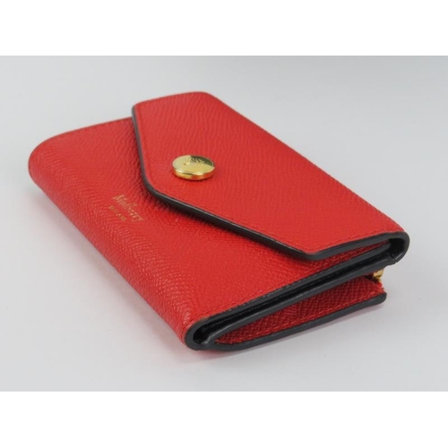 224 - A Mulberry poppy red leather folded multi-card wallet. Gold hardware, cash, card and coin storage. O... 