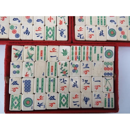 276 - A vintage Chinese cased Mah Jong game set. With bamboo backed carved bone pieces and ‘The Queen’s Cl... 