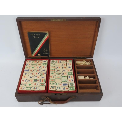 276 - A vintage Chinese cased Mah Jong game set. With bamboo backed carved bone pieces and ‘The Queen’s Cl... 