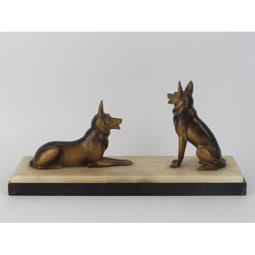 33 - A bronzed spelter model of two Alsation dogs, early/mid 20th century. Mounted on an onyx and marble ... 