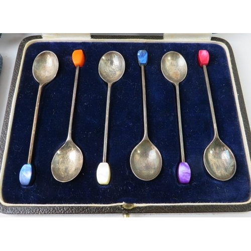 387 - Two cased sets of silver coffee bean teaspoons. One with fluted bowls, the other with stylised colou... 