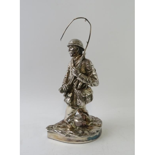 389 - A hallmarked silver model of a fly fisherman, signed R Chadwick. Hallmarked for Sheffield 1986, make... 