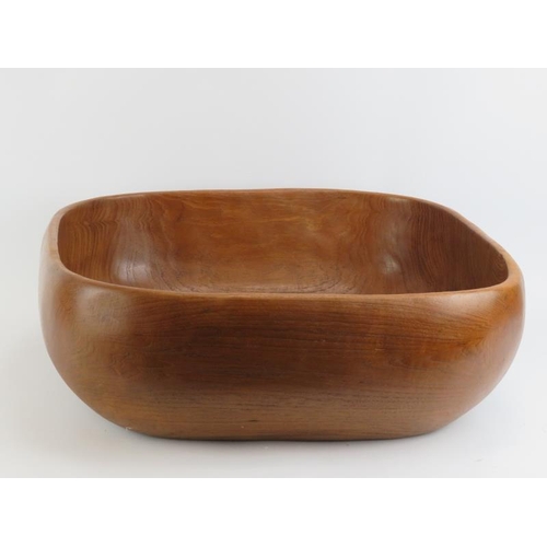 41 - A very large carved teak wood bowl with matching serving utensils. The bowl hewn from section of woo... 