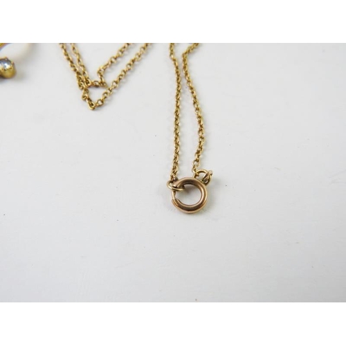 424 - A pretty pearl and diamond set wishbone pendant on yellow metal chain, bolt ring stamped 9ct, 5grams... 