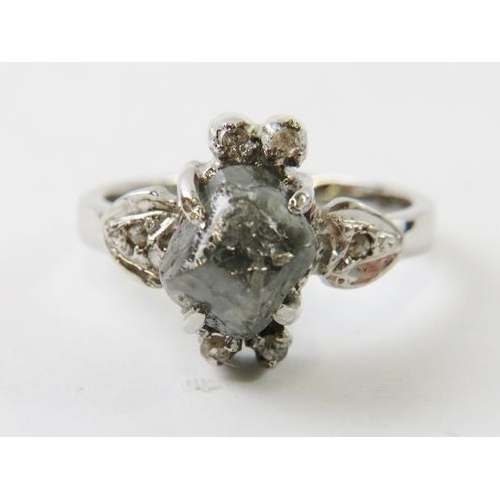 439 - A rough diamond ring in white metal, accompanied with a Gemmological Institute & Laboratory report s... 