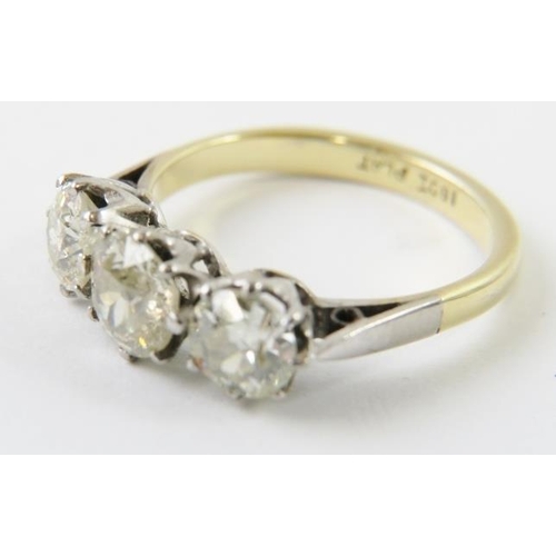 443 - A three stone diamond ring, the old cut diamonds claw set in white to a yellow metal shank.  The dia... 