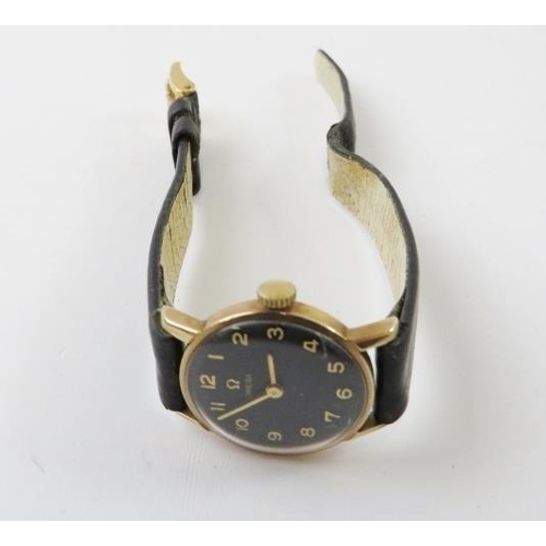 455 - A lady’s Omega 9ct yellow gold cased manual wind wristwatch with black dial and gilt Arabic numerals... 