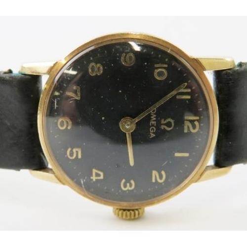 455 - A lady’s Omega 9ct yellow gold cased manual wind wristwatch with black dial and gilt Arabic numerals... 