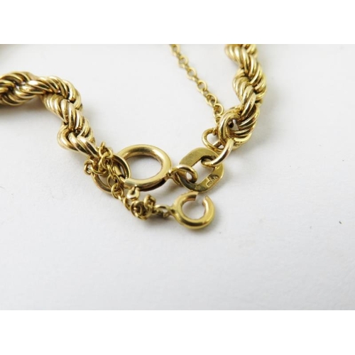 468 - A 9ct yellow gold rope twist necklace, 40cm approx; and a vintage yellow metal gate link bracelet wi... 