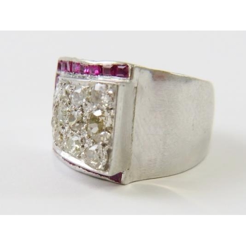 488 - A retro 1940’s diamond and ruby Tank ring, with a raised panel pave set with old round cut diamonds ... 