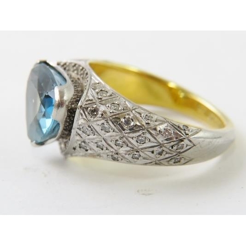 493 - A heavy18ct gold and platinum, aquamarine and diamond ring by John Gorbould.  The strong blue curved... 