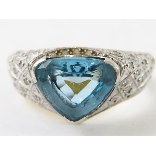 493 - A heavy18ct gold and platinum, aquamarine and diamond ring by John Gorbould.  The strong blue curved... 