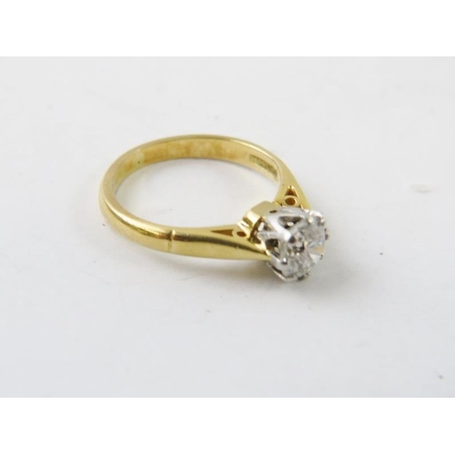 494 - A diamond single stone ring.  The round brilliant cut diamond claw set in white to a yellow metal sh... 