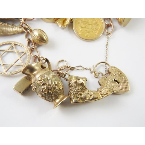 497 - A rose gold charm bracelet, most links stamped 9 .375, with yellow metal heart padlock stamped ‘9 37... 