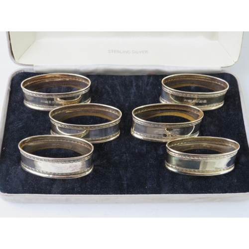 58 - A boxed set of six silver napkin rings of oval form hallmarked for London 1986, maker Ari D Norman. ... 