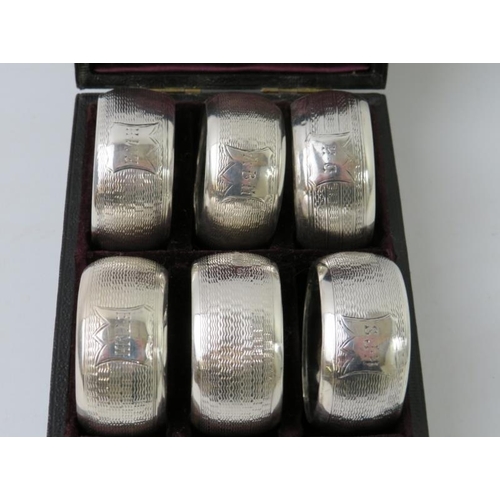 65 - A cased set of six late Victorian silver napkin rings, hallmarked for Birmingham 1893, maker Nathan ... 