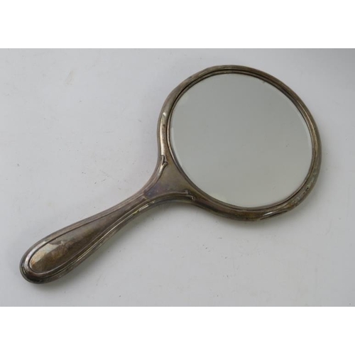 66 - A heavy silver backed dressing table mirror, hallmarked for Birmingham, marks rubbed. Length 26cm, a... 