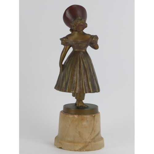 86 - A vintage gilt and bronzed spelter figure of a girl in dress and bonnet, early/mid 20th century. Mou... 