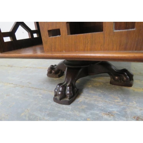 702 - An Edwardian rosewood revolving tabletop bookcase, with brass ball finials and pierced fretwork side... 