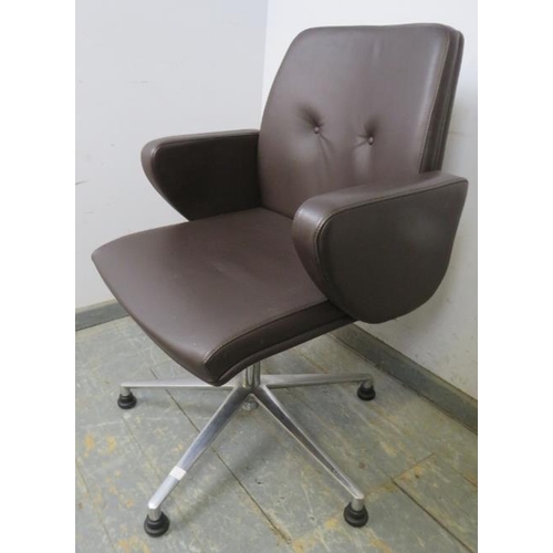 705 - A mid-century style swivel desk chair, upholstered in buttoned brown leather, on cast aluminium supp... 