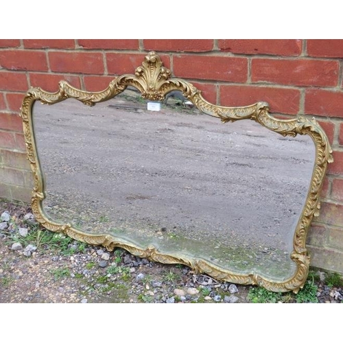 708 - A vintage wall mirror in the Italian taste, the shaped gilt metal surround modelled as acanthus leav... 