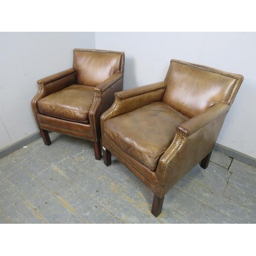 709 - A pair of antique style club chairs, upholstered in distressed brown leather with brass studs, on sq... 