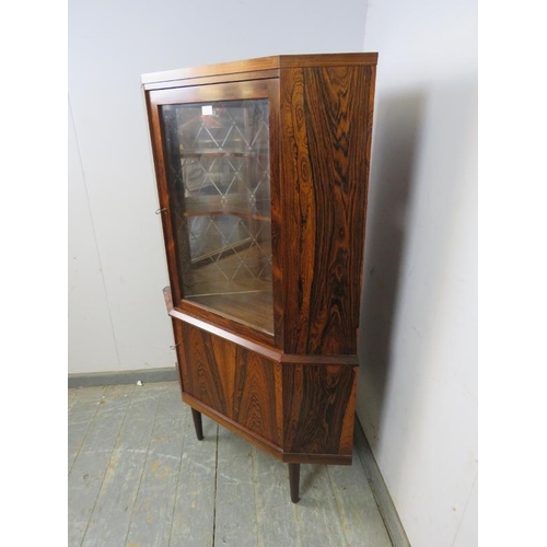 719 - A mid-century Danish corner drinks cabinet by Eli Christensen, the glazed door opening onto a mirror... 