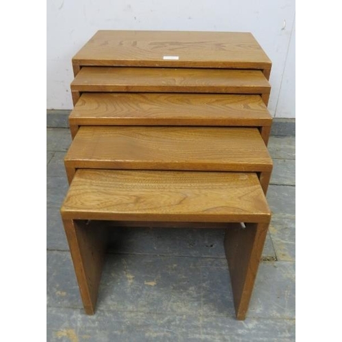 725 - A nest of five elm tables by Ercol (model no. 495) each with pierced handles to either side, on stil... 