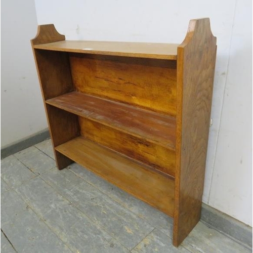 726 - A vintage light oak low open bookcase, of two shelves, on stile supports. 
H76cm W79cm D18cm approx.... 