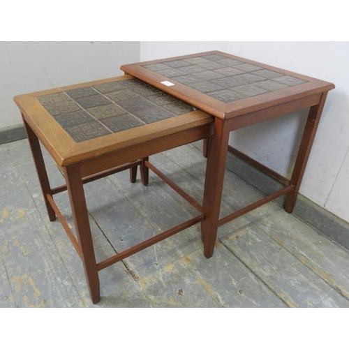 728 - Two mid-century Danish teak nesting tables, the tops with inset geometric tiles, on square supports ... 