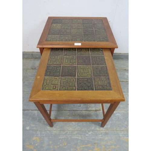 728 - Two mid-century Danish teak nesting tables, the tops with inset geometric tiles, on square supports ... 