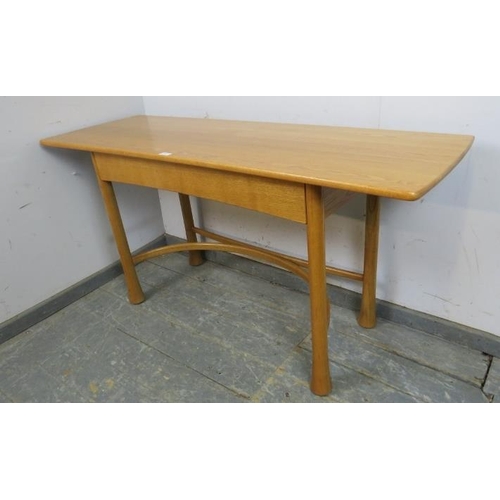 732 - A contemporary ash console table by Ercol, housing two short blind drawers, on fluted supports with ... 