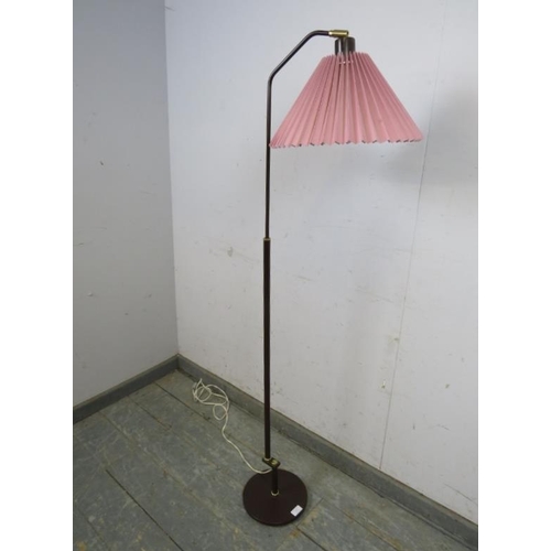 737 - A mid-century Danish floor-standing reading lamp, the height adjustable bronzed column on a circular... 