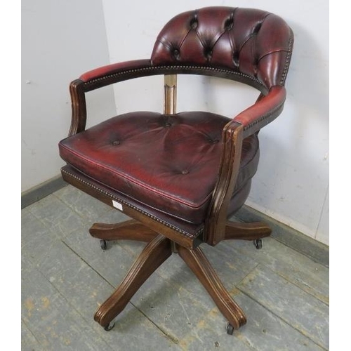 742 - A vintage mahogany captain’s desk chair, with recline and swivel function, upholstered in buttoned o... 